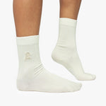 Beige socks with a logo on a white background
