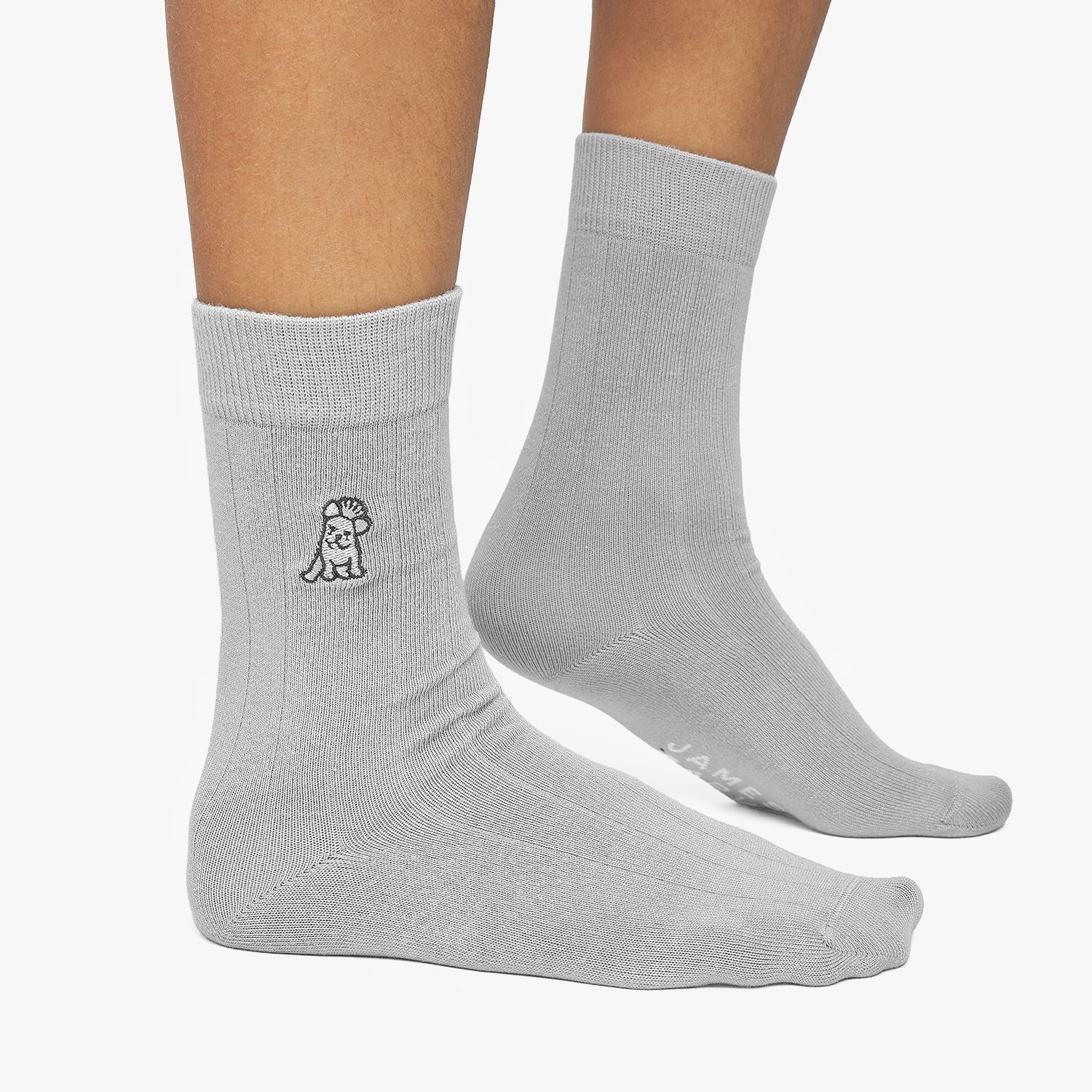 Gray socks with a small logo on a white background