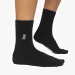 Black socks with a small logo on a white background