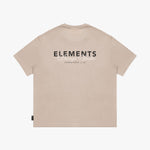 Back view of a beige t-shirt laid flat, featuring a large "ELEMENTS Design Studio" graphic in black and white