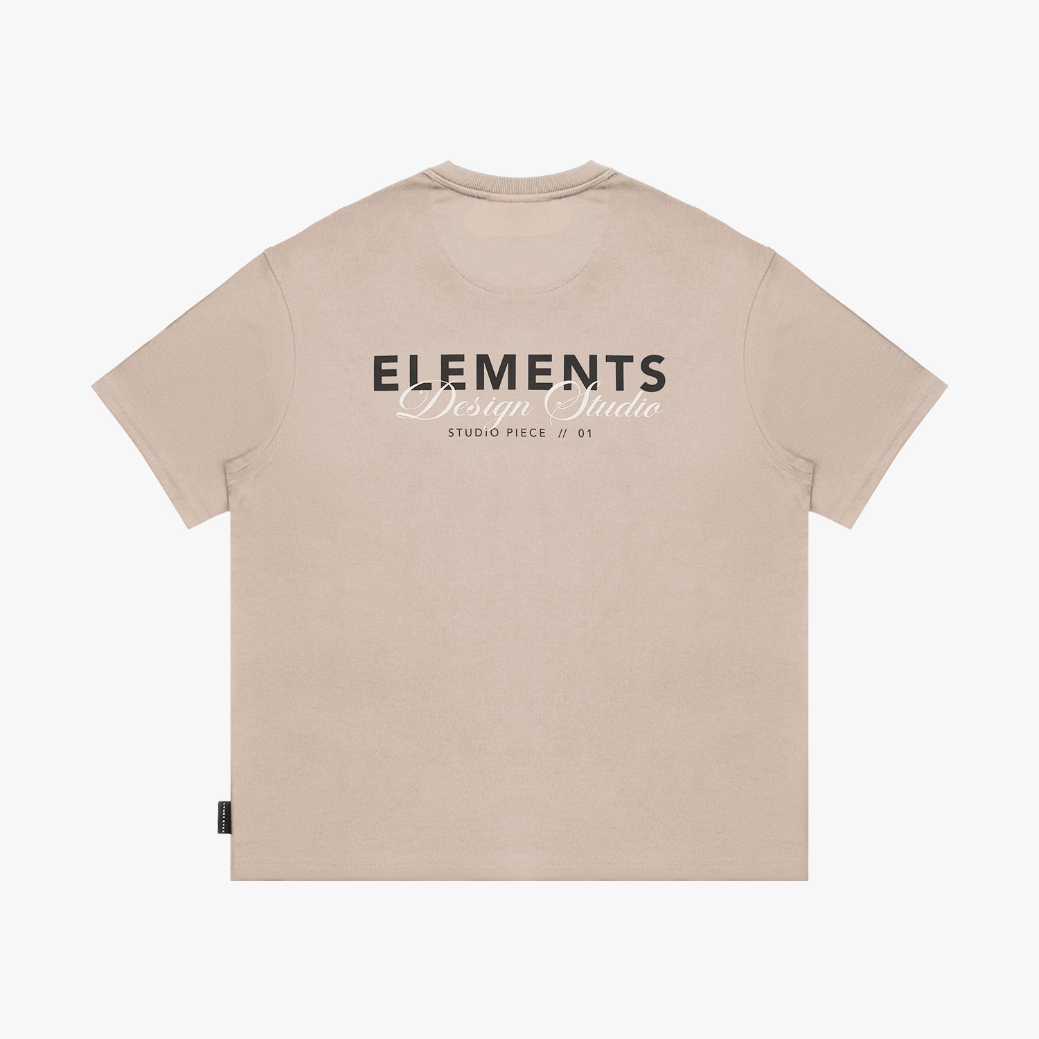 Back view of a beige t-shirt laid flat, featuring a large "ELEMENTS Design Studio" graphic in black and white