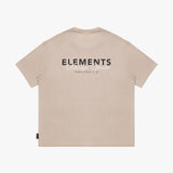 Back view of a beige t-shirt laid flat, featuring a large "ELEMENTS Design Studio" graphic in black and white