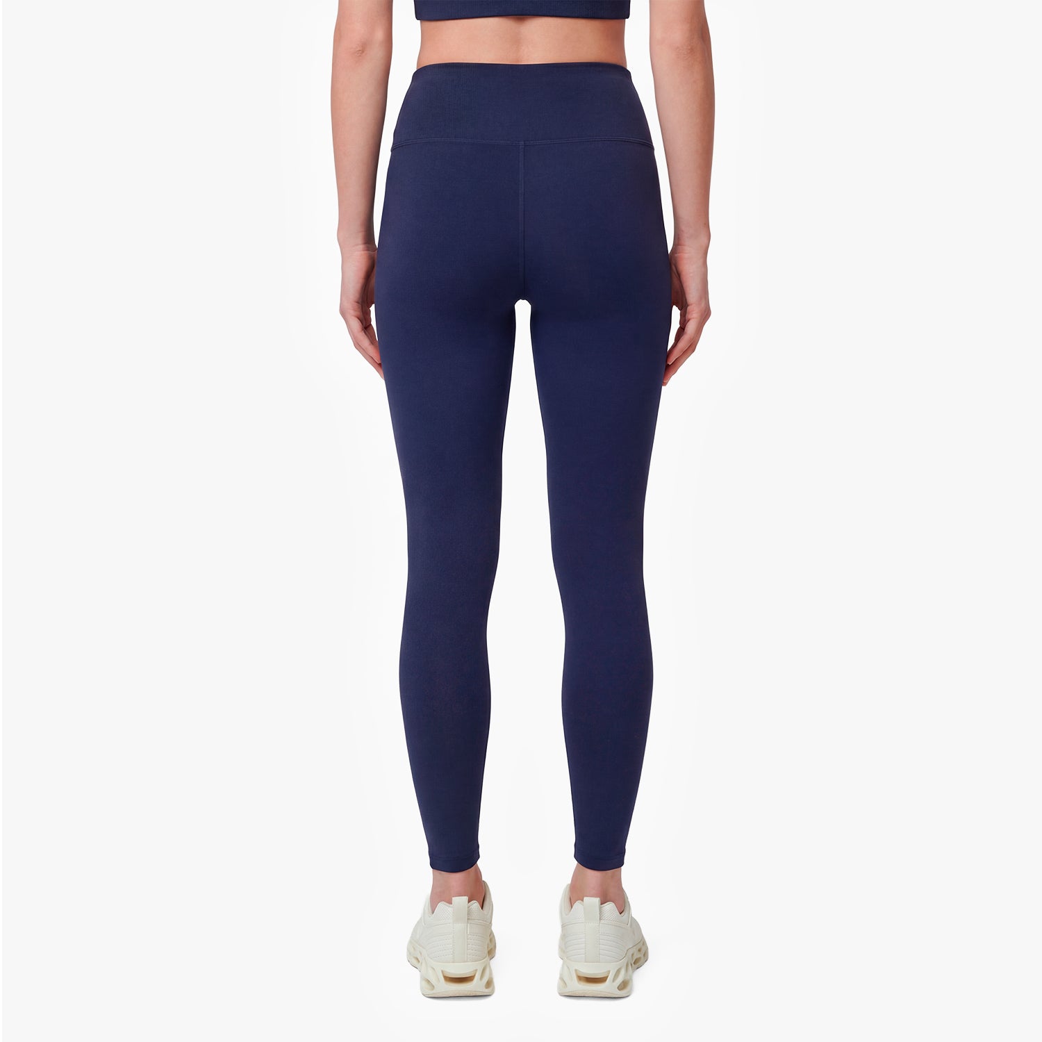 Navy blue leggings worn by a person on a white background