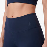 Navy blue athletic leggings with a logo on a white background