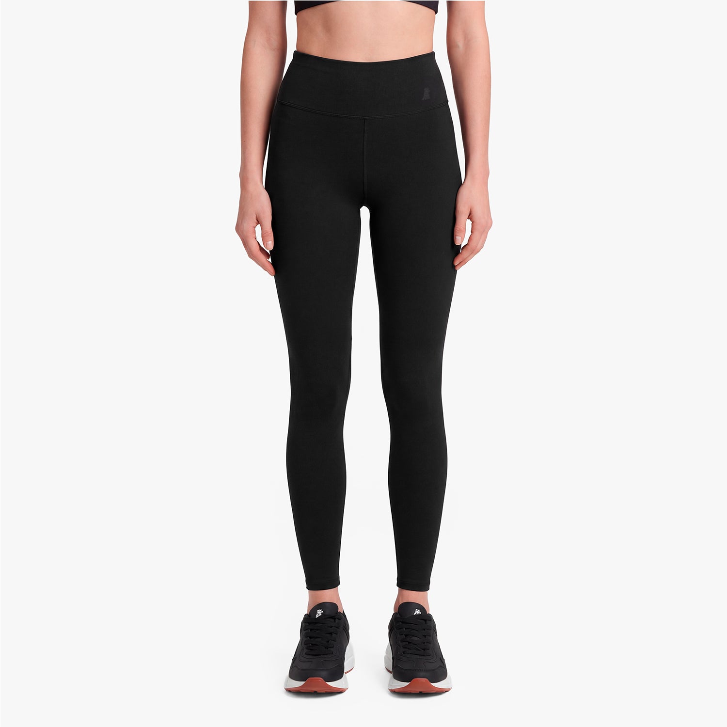Person wearing black leggings on a white background