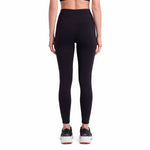 Person wearing black leggings on a white background