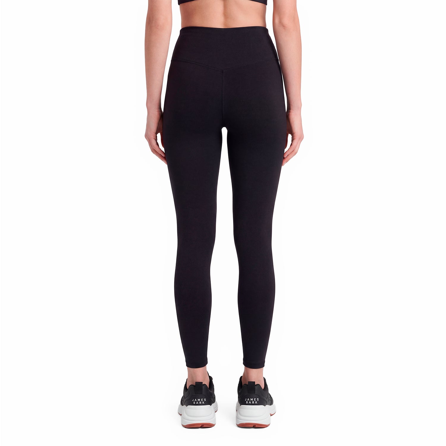 Person wearing black leggings on a white background