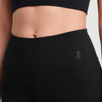 Black athletic pants with a small logo on a plain background