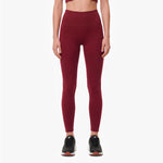 Maroon leggings worn by a person on a white background
