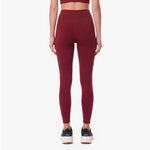 Maroon leggings worn by a person on a white background