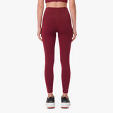 Maroon leggings worn by a person on a white background