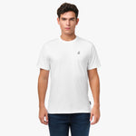 Man wearing a white t-shirt with a small logo on a white background