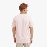 Back view of a man wearing a light pink t-shirt on a white background