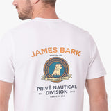 A man wearing a white T-shirt, viewed from the back. The shirt features a large graphic print with the text 'JAMES BARK' in orange, a circular crest with a dog illustration, and 'PRIVÉ NAUTICAL DIVISION' in dark blue text below.