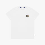 A white T-shirt with a small circular crest printed on the left chest. The inner collar features a contrasting navy blue trim, and a small black tag is visible near the bottom-right hem
