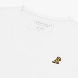 Angled close-up of the white v-neck t-shirt's neckline and chest, highlighting the inner printed label and the detailed yellow and black embroidered dog logo