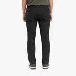 Back view of a person wearing black pants on a white background