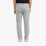 Back view of a person wearing light gray pants on a white background