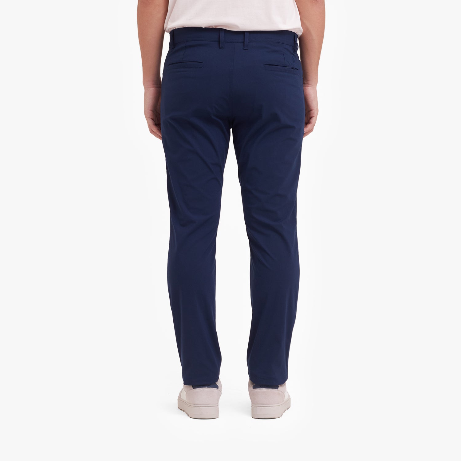 Back view of navy blue pants worn by a person on a white background