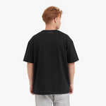 Back view of a man wearing a black t-shirt on a white background