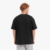 Back view of a man wearing a black t-shirt on a white background