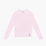 A flat lay shot of a light pink, long-sleeved crewneck t-shirt on a white background. A small, embroidered dog logo is on the bottom left hem.