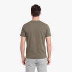 Man wearing a green t-shirt on a white background