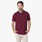 Man wearing a maroon polo shirt with a logo on a white background