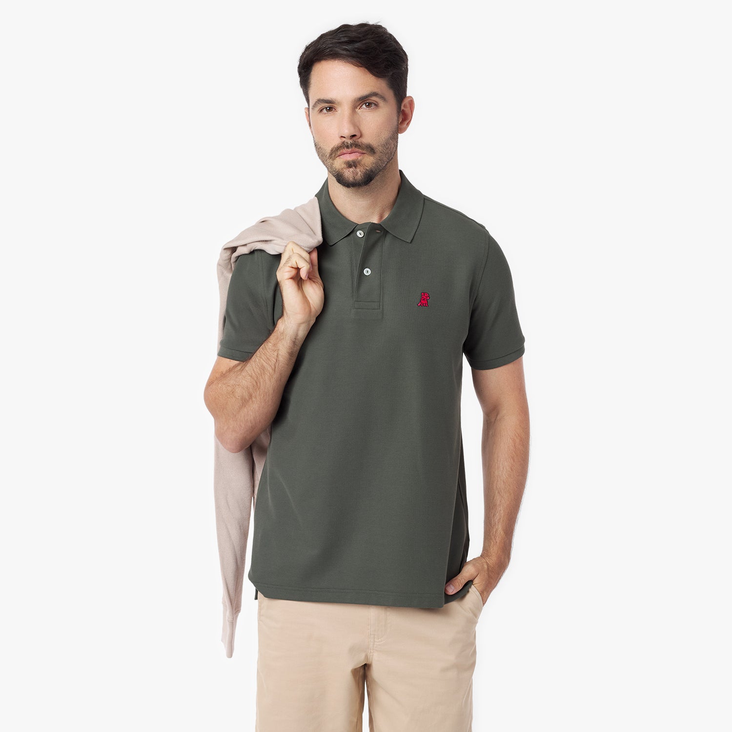 Man wearing a green polo shirt with a red logo on a white background