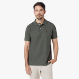Man wearing a green polo shirt on a white background