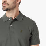 Close-up of a green polo shirt with a small logo on a white background