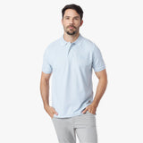 Man wearing a light blue polo shirt on a white background