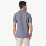 Back of a man wearing a gray polo shirt on a white background