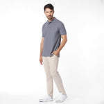 Man wearing a gray polo shirt and beige pants on a white background