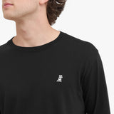 Black long-sleeve shirt with a small white logo on a plain background