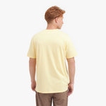 Back view of a man wearing a light yellow t-shirt on a white background
