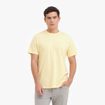 Man wearing a light yellow t-shirt on a white background
