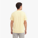 Back view of a man wearing a light yellow t-shirt on a white background