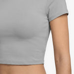 Gray t-shirt worn by a person on a white background