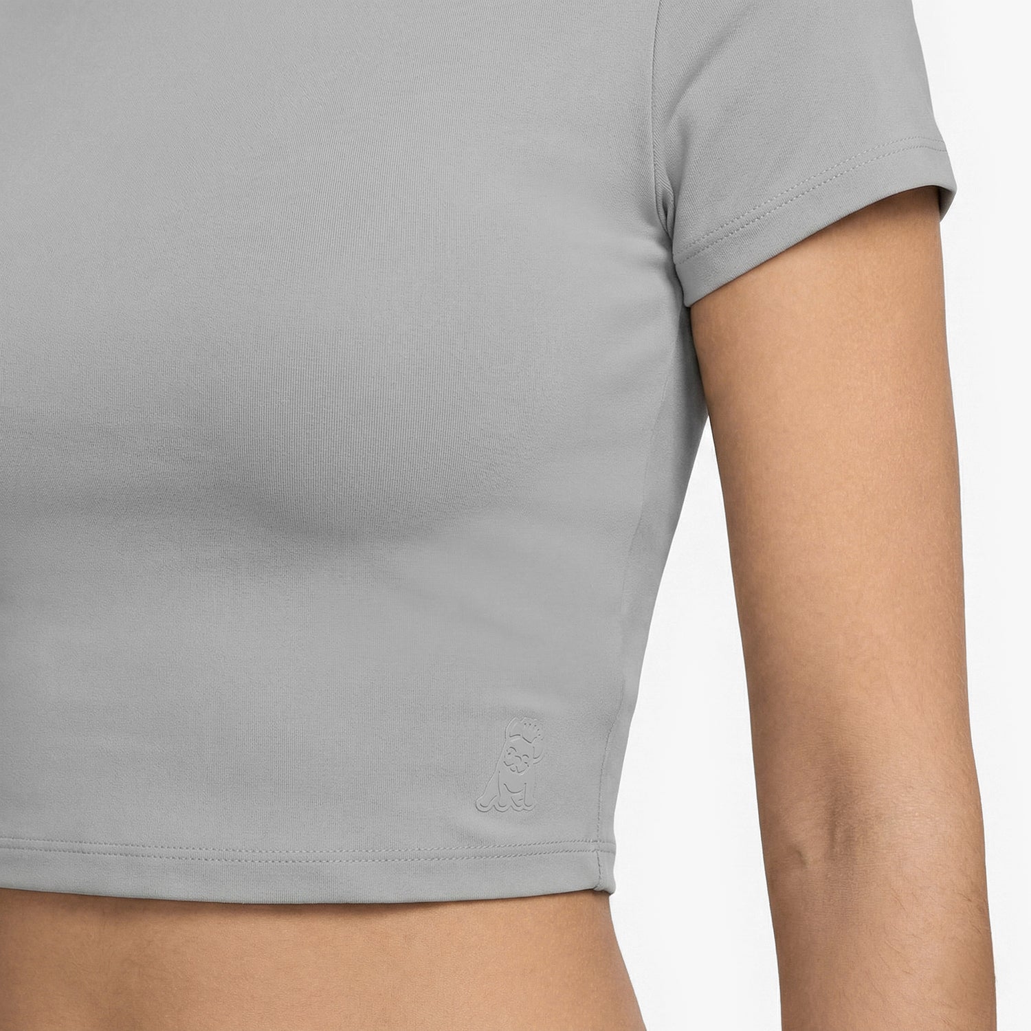 Gray t-shirt worn by a person on a white background