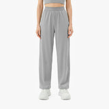 Person wearing gray high-waisted pants on a white background