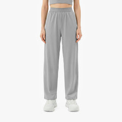 Person wearing gray high-waisted pants on a white background