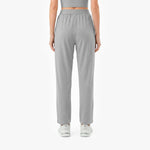 Person wearing gray high-waisted pants on a white background