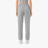 Person wearing gray high-waisted pants on a white background