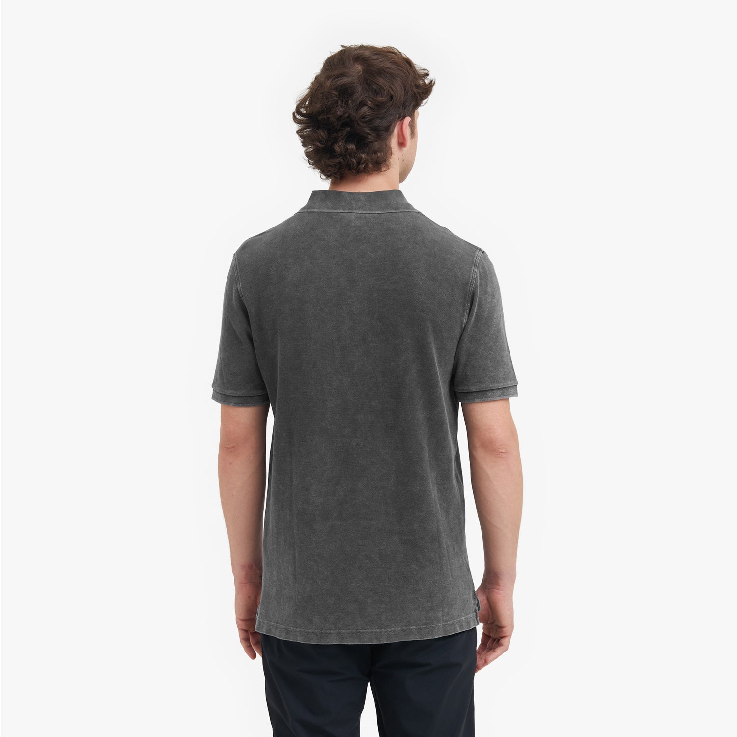 Back view of a man wearing a gray polo shirt on a white background