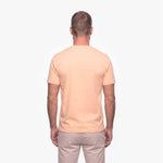 Man wearing a beige t-shirt on a white background