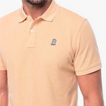 Beige polo shirt with a small logo on a white background
