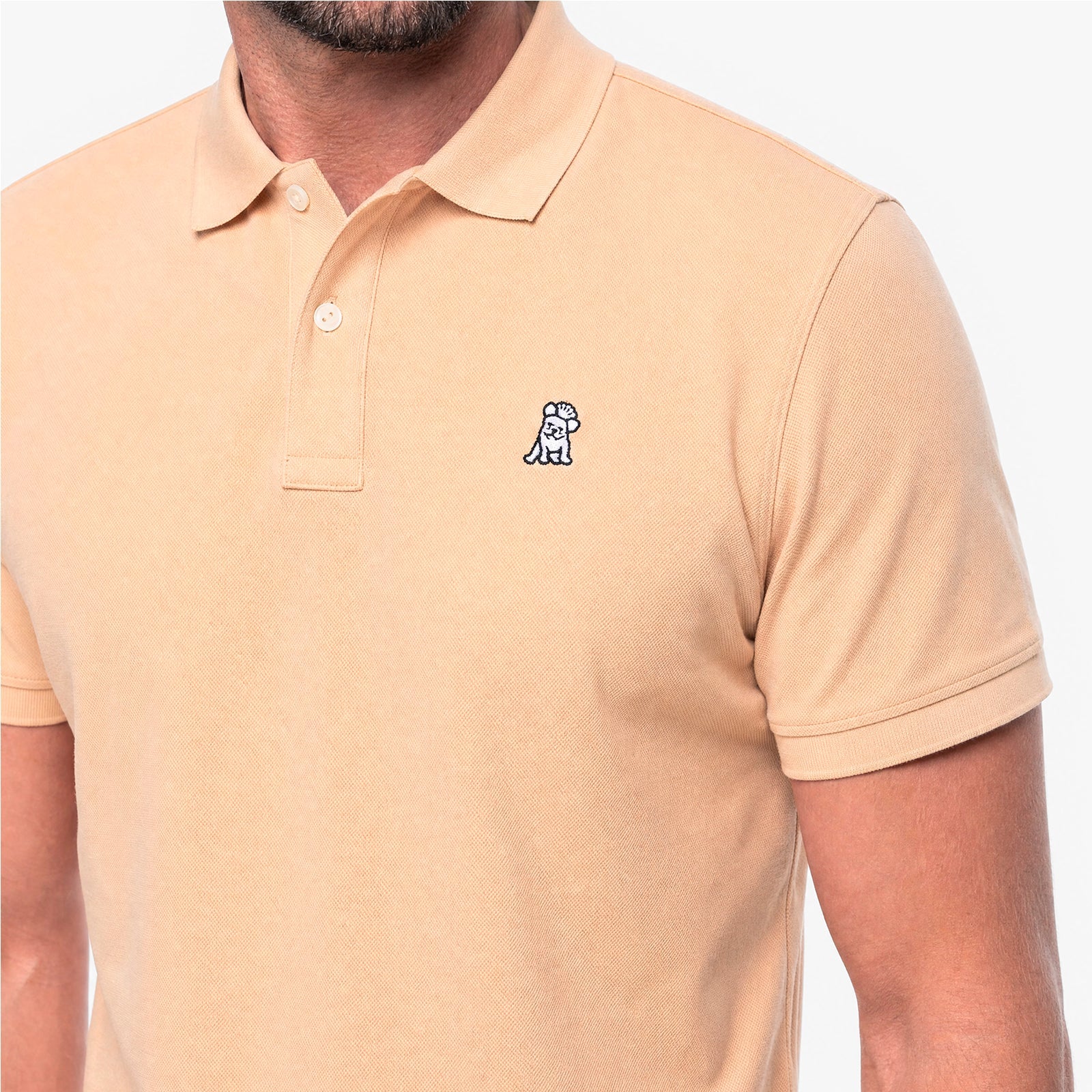 Beige polo shirt with a small logo on a white background