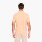 Man wearing a beige polo shirt on a white background