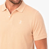 Beige polo shirt with a small logo on a white background